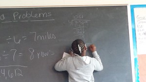 At the board doing math